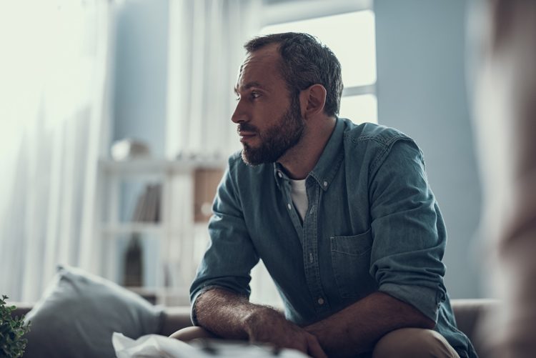 Relapse Stats, man sitting at home looking thoughtful - relapse