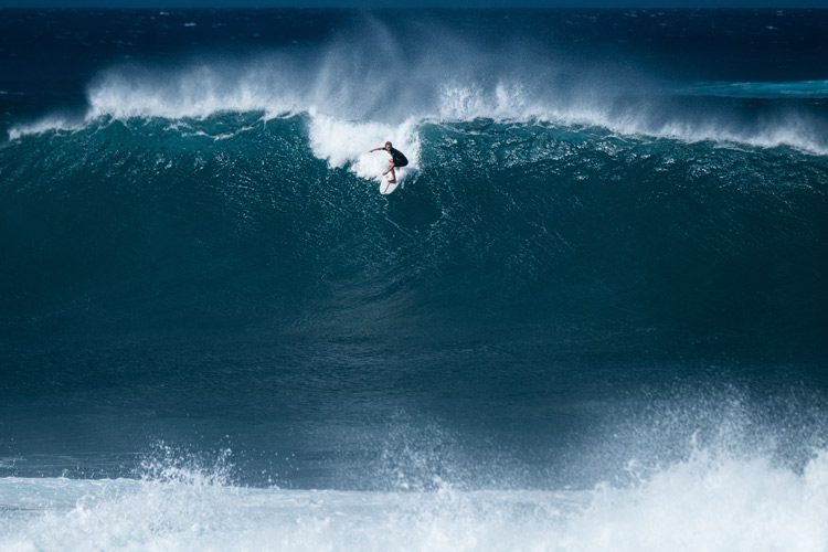 surfer riding enormous wave - urge surfing