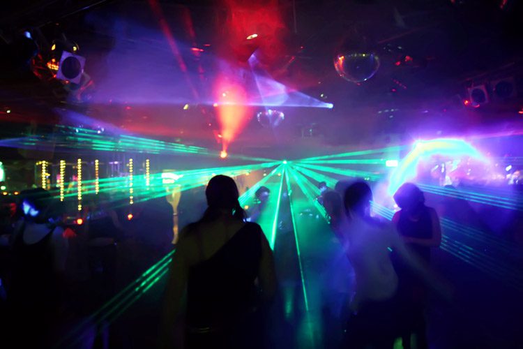 colored laser lights inside a rave or night club - club drugs